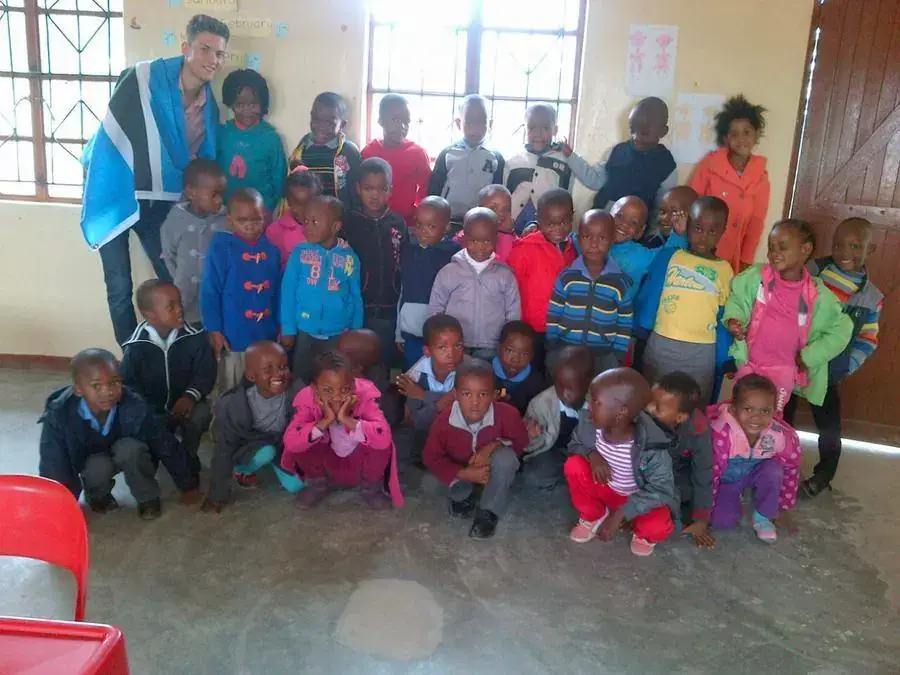 Early learners and a volunteer in the classroom
